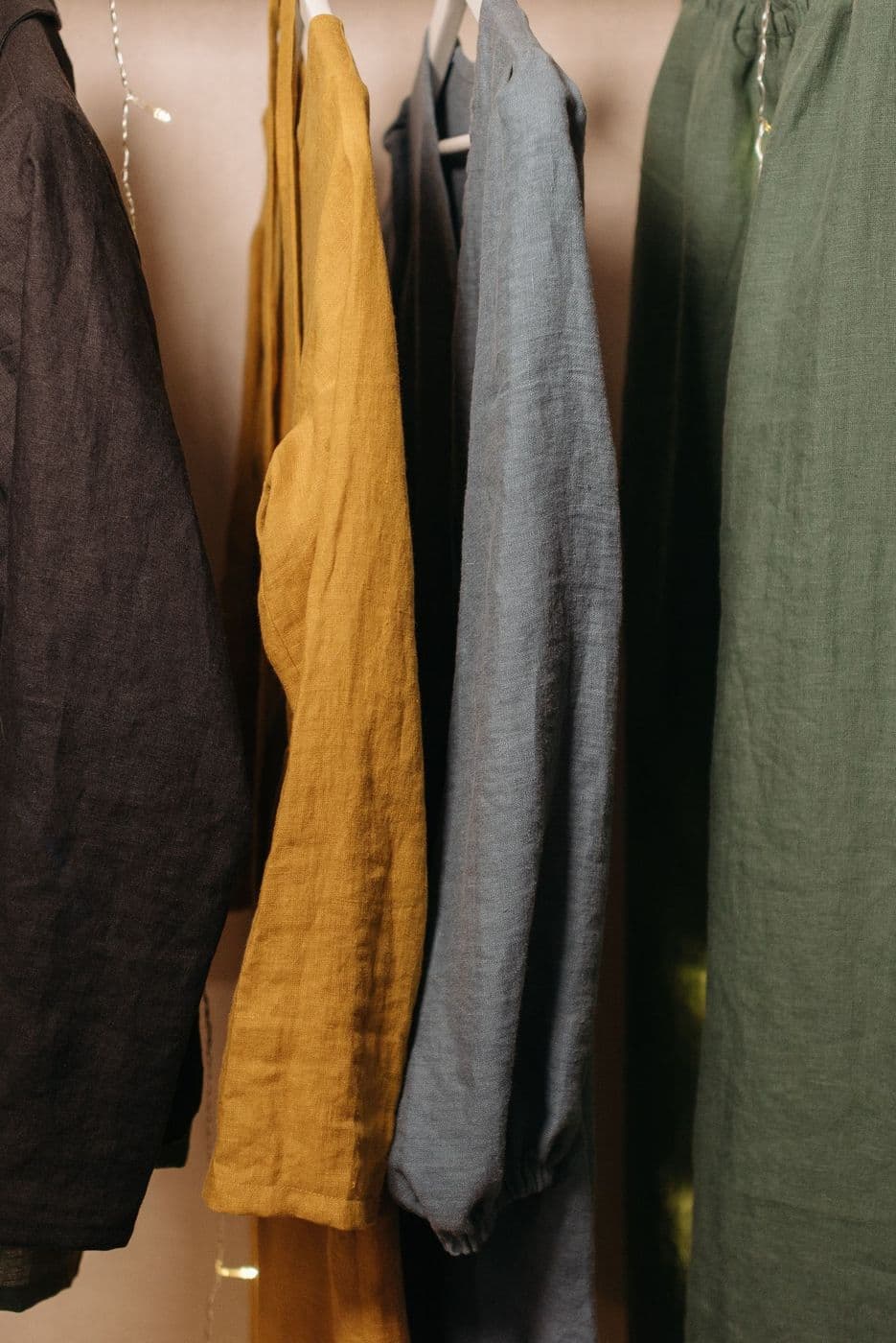 Linen shirts in olive and mustard on hangers